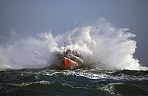 Trent Class relief lifeboat based in Alderney, Channel Islands, breaks through heavy swell in the English Channel.