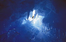 Four times Whitbread sailor and mountaineer, Skip Novak, climbing through an ice cave in Antarctica.