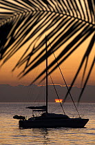 A Prout catamaran during sunset off a Florida beach.
