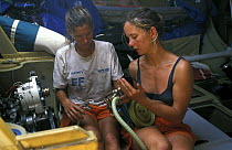 Lisa Macdonald and Anna Drougge carrying out repair work on board "EF Language" during the Whitbread Round The World Race, 1997-98.