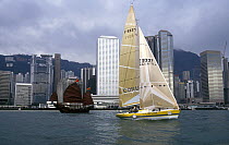 Yacht "Corum" sails past a traditional Chinese junk boat in Hong Kong harbours, Corum Cup.