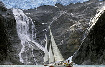 Skip Novak's yacht "Pelagic" sails beneath a glacial waterfall in southern Chile, South America.