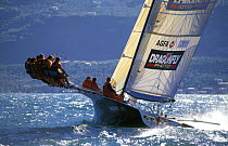 Ten crew on the trapeze of the "Classe Libera" Dragonfly at Centomiglia, Lake Garda, 1995.