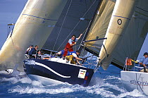 Crew on ID35 "Smiling Bulldog" prepare to hoist the spinnaker at the windward mark during Key West Race Week, 2000.