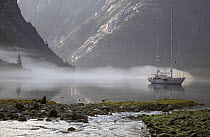 118ft S&S designed superyacht, "Timoneer" anchored in a misty calm in Fords Terror, Tongass National Forest, south-east Alaska.