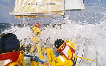 Waves break over the deck of "Intrum Justicia" as they move through the Southern Ocean under spinnaker during the Whitbread Round the World Race, 1993.