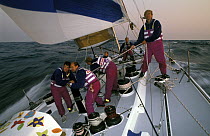 Crew at work aboard "The Card" under full sail, in the Whitbread Round the World Race, 1989-90.
