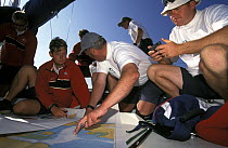 Last minute checks aboard "Barlo Plastics" at Cork Week. Navigator Ian Moore (2nd left) goes over local charts with the tactitian. Olympic sailor and GBR Challenge helmsman Andy Beadsworth (right) is...