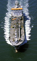Aerial view of an oil tanker as it powers through the sea.