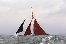100 year old classic gaffer "Wender" is hidden by the swell off Dartmouth in Devon, UK.
