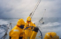 Crew wearing heavy weather gear in dangerous conditions on "Intrum Justitia" racing in the Round the Whitbread World Race, skippered by Lawrie Smith, 1993-94.^^^ the team won the second leg of the rac...