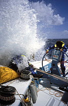 Helmsman is fully geared up in waterproofs on "EF Language" Skippered by British yachtsman Lawrie in the Whitbread Round the World Race, 1993-94.   ^^^The team won the second leg of the race and bro...