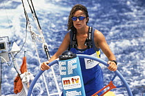 Yachtswoman helming "EF Language" during the Whitbread Round The World Race, 1997-98.