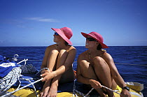 Female crew of "EF Language" relax on deck during Whitbread Round the World Race, 1997-98.