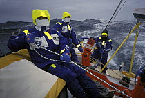 Crew on "EF Language" wear full heavy weather clothing, competing in the Whitbread Round the World Race, 1997-1998.   ^^^The team went on to win the overall campaign.