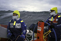 Crew on "EF Language" wear full heavy weather clothing while racing during the Whitbread Round the World Race 1997-1998.