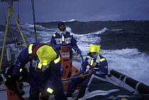 Crew on "EF Language" wear full heavy weather clothing while racing during the Whitbread Round the World Race, 1997-1998.