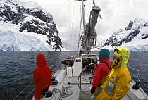 Skip Novak's yacht "Pelagic" motorsails along the Lemaire Channel, Antarctic Peninsula.