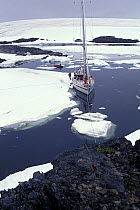 Skip Novak's yacht "Pelagic" lies along the sea ice with lines ashore at the Ukranian base Vernadsky (ex-Faraday) in the Argentine Islands, Antarctic Peninsula.