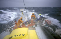 Crew aboard "EF Language" wear full heavy weather clothing while racing during the Whitbread Round the World Race, 1997-1998.