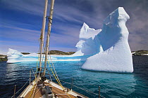Bow of the Kotick approaching a carved iceberg, Antarctic Peninsula