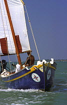 A traditional lateen rig sail boat or chiggiotta, Lagoon of Venice, Italy.