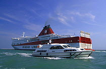 Big tourist ferry and a small tourist canal boat on the lagoon of Venice, Italy.