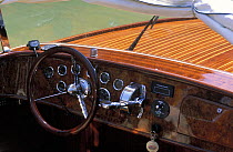 Console and steering wheel of antique wooden motorboat, Venice, Italy.