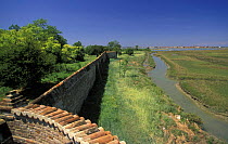 Boundary wall of Lazzaretto Nuovo island, at the entrance of the Venetian lagoon. It has been used for controlling the water ways to inland since ancient times, Venice, Italy.