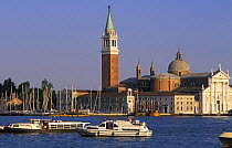 View of the bell tower (campanile) and monastery San Giorgio Maggiore. Masts of yachts moored in the island of San Giorgio's marina can be seen, Venice, Italy.