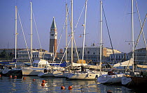 Yachts moored in the marina at San Giorgio Maggiore Island with Campanile di San Marco in the background, Venice, Italy.