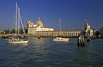 Cruising towards Canale Grande (Great Canal) passing Santa Maria della Salute church, Dogana point, Venice, Italy.