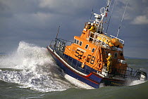 The Yarmouth, IOW Lifeboat powers through the waves in the Solent, the crew can be clearly seen on deck. ^^^ The largest of the fleet and designed to lie afloat. She carries a Y class inflatable which...
