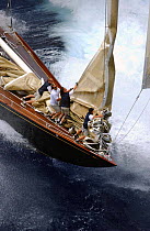 Foredeck crew attending to the sails as the J-Class yacht "Velsheda" races along at Antigua Classic Yacht Regatta, 2003.