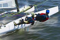 Trapezing aboard a HT 18 class catamaran at speed during Newport Regatta, Rhode Island, USA 2003.
