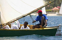 Skipper helming a workboat during the Grenada Sailing Festival, Caribbean 2003.