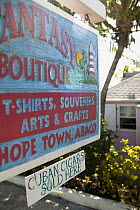 Sign advertising souvenirs and Cuban cigars for sale in Hope Town, Abaco, Bahamas.