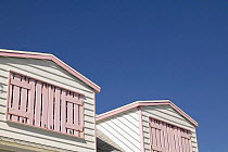 Pink wooden shutters and eaves adorn a traditional home in Hope Town, Abacos, Bahamas.