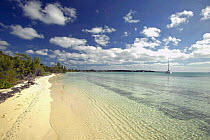 Tropical beach with anchored yacht, Bahamas