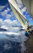 Water washes over the decks of the heeling schooner "Windrose" at Antigua Classic Yacht Regatta, Caribbean 2004.