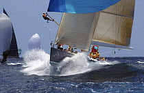 "All Smoke" the Reichel/Pugh 78, sails downwind with a crewman at the end of the spinnaker pole preparing to pop the kite. Antigua Race Week 2004. ^^^Skippered by Jochen Schuemann