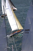 Mike Slade's "Leopard of London" is framed by the ketch rig of Peter Harrison's Farr 115 "Sojana" during Antigua race week, 2004.