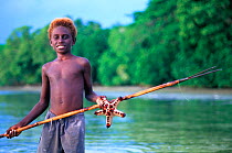 Young boy with fishing spear and starfish, New Ireland, Papua New Guinea
