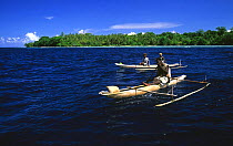 Men in traditional outrigger boats, pirogues, New Ireland, Papua New Guinea