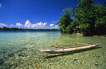 Traditional canoe (pirogue) in front of small island between New Hannover and New Ireland, Papua New Guinea