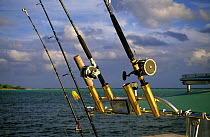 Fishing rods in holders on boat, Little Cayman, Cayman Islands.