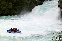 Huka Falls jet boat, Huka Falls, Wairakei River, Taupo, New Zealand. Huka Falls is one of New Zealand's most visited attractions, more than 220,000 litres of water cascades over the cliff face per sec...