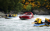 White water rafters and the Shotover jet boat, Shotover River, Queenstown, New Zealand.
