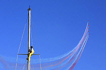 Red Arrows display during the Dartmouth Regatta, with a man up a mast. Devon, England, UK.