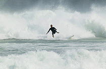 Surfer falling off board in white water, Black Head, Dunedin, New Zealand.